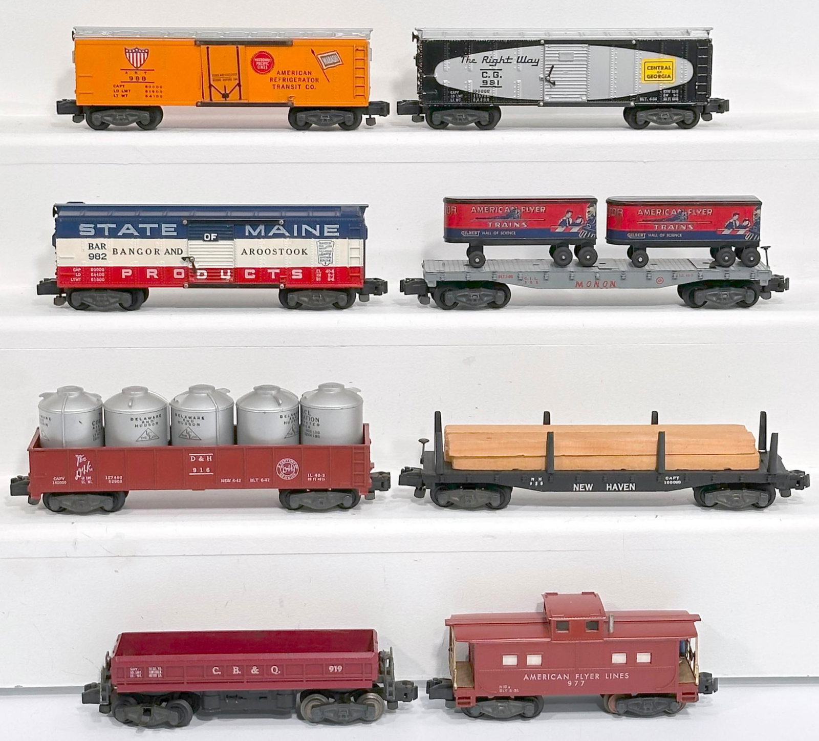 American Flyer Postwar S Gauge Eight (8) Assorted Freight Cars: American Flyer Postwar S Gauge Eight (8) Assorted Freight Cars, including 982 in C7 plus, 988 in C7 plus, 981 in C7, 928 with lumber load in C7 plus, 977 in C7 plus, 919 in C7, 916 with silver caniste