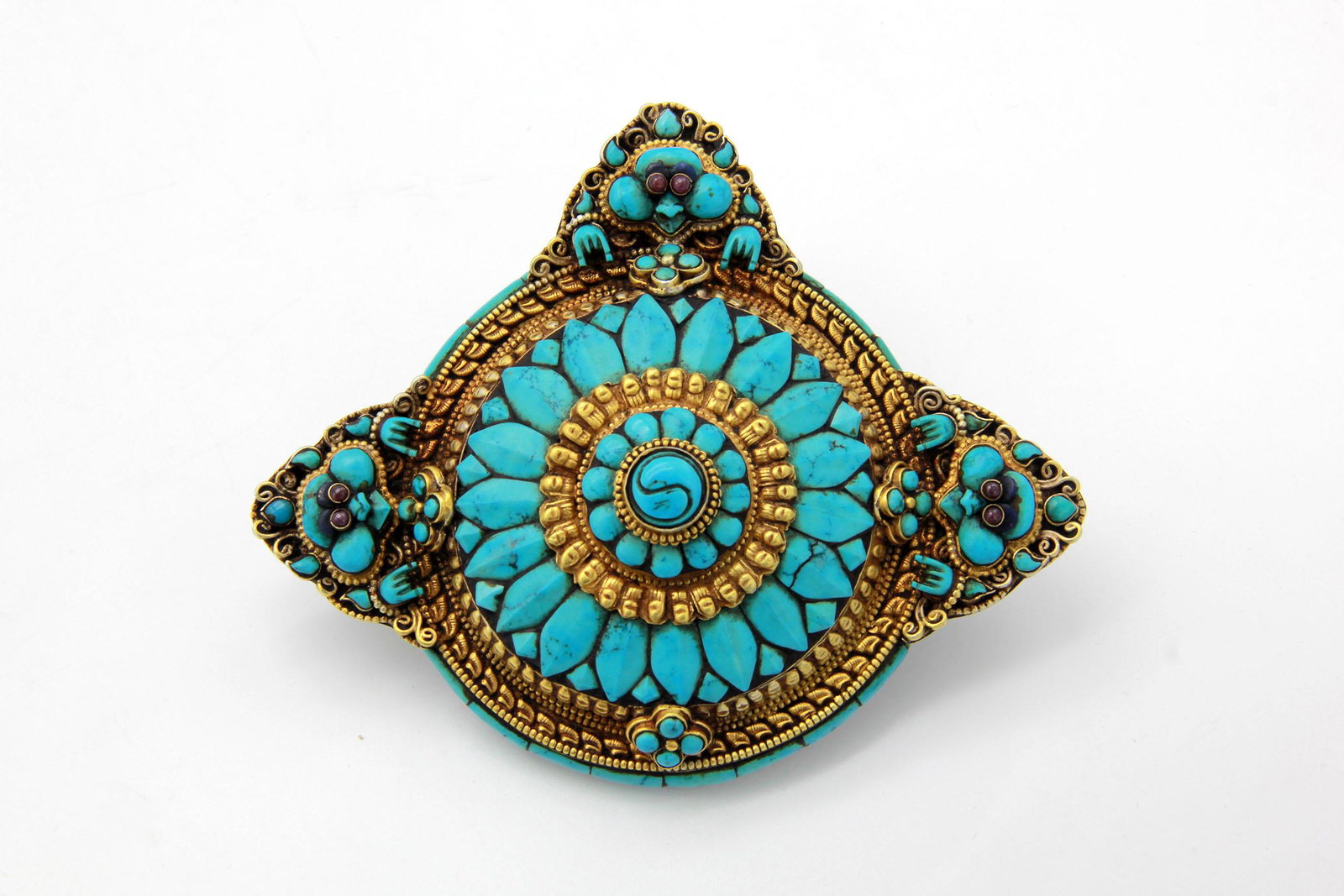 A Tibetan Mooneater Brooch with Three Faces: A Mooneater Brooch with Three Faces Tibet, Antique Silver with Gold Gilt and Tibetan Turquoise Stones 10 cm x 12 cm