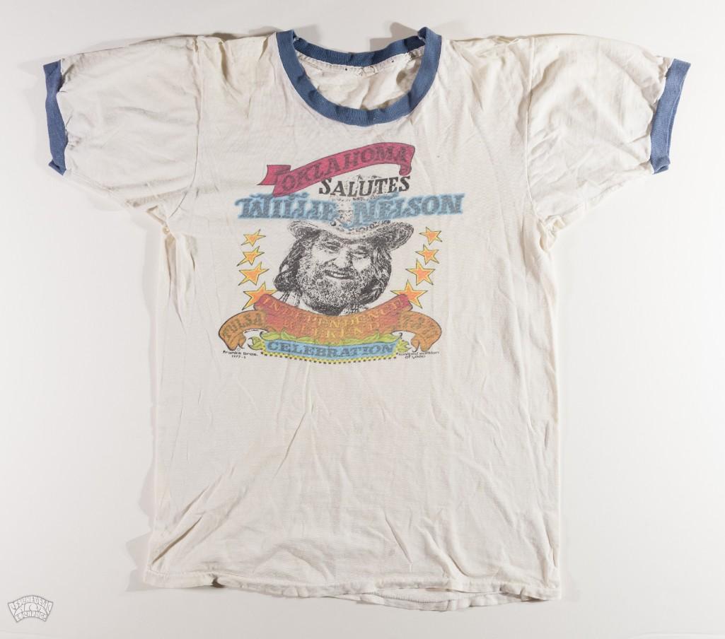 Lot of Willie Nelson T-Shirt & Tickets: This lot features a collection of a vintage Willie Nelson t-shirt and includes original tickets. --CRITICAL DETAILS-- --TITLE: Lot Of Willie Nelson T-Shirt & Tickets --GRADE: