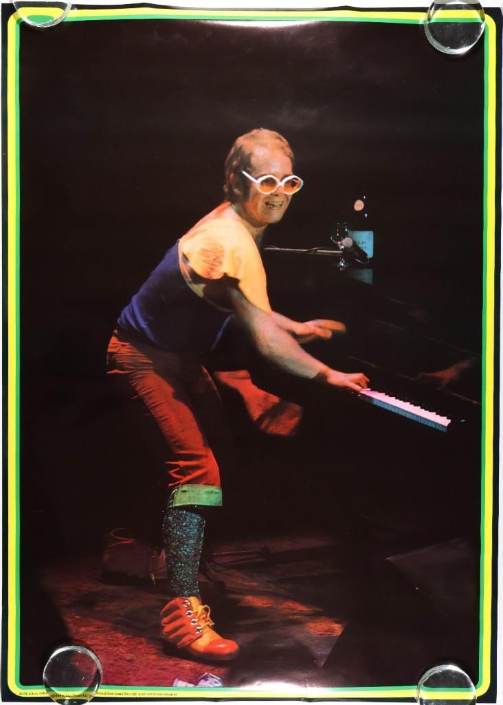 1970s Elton John Big O B118 Poster Near Mint 85: Big-O posters were UK-style commercial posters that were created for some of the best artists of the day. This headshop Big-O poster features the great Elton John playing piano. Condition Details: Min