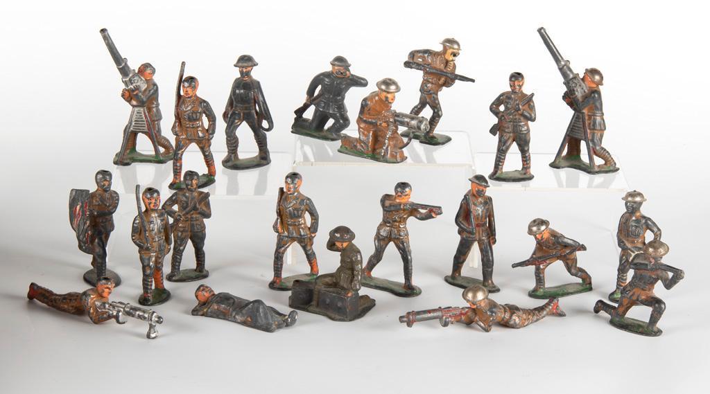 Grouping of WWI Painted Lead Toy Soldiers: American, mid 20th century. Lot includes 21 assorted lead toy soldiers, all with paint loss with age and use, many without helmets, single resting soldier under blanket marked Barclay #761 made in USA