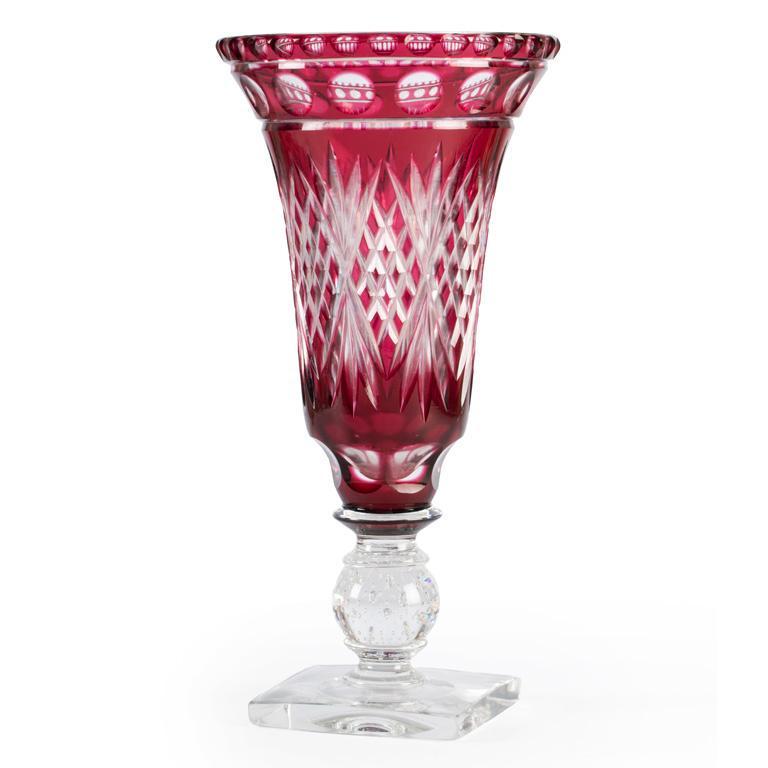 A Bohemian Cranberry Cut Glass Vase: Continental, 20th century. A bohemian cranberry cut glass vase, the decorated vase on a square base; ht. 13, dia. 7 inches. Overall good condition. â€‹â€‹â€‹â€‹â€‹â€‹â��