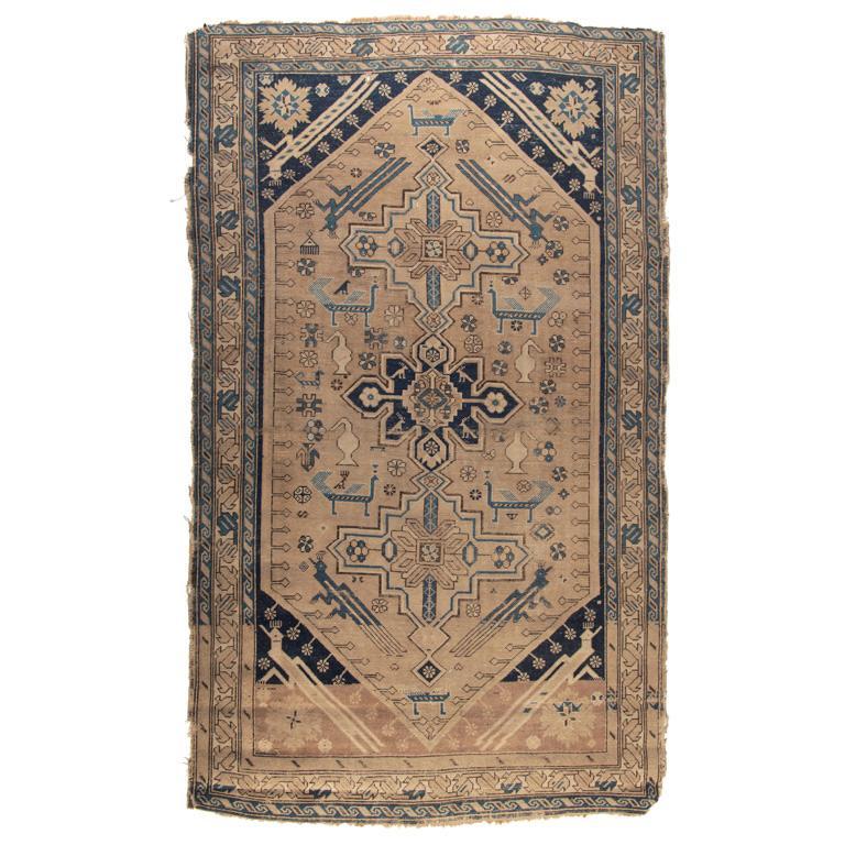 A Kazak Area Rug: Oriental, first quarter 20th century. Kazak area rug; 74 x 46 inches. Overall good condition. Minor hole, loss to fringe and edges throughout rug.