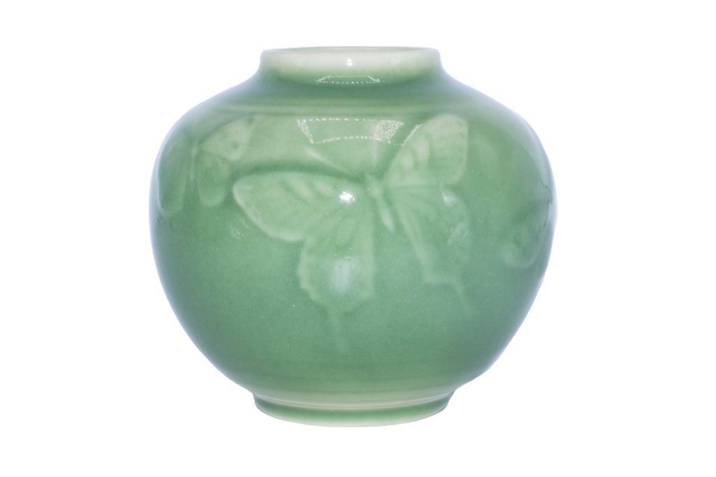 A Rookwood Pottery Gloss Celadon Butterfly Vase: American (Cincinnati, Ohio), 20th century. A green celadron Rookwood Pottery Vase dating to 1944. Measures 4.5 inches and marked XLIV/6509. Overall good condition, some light crazing throughout.