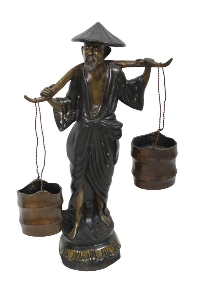 China, 20th century. A cast bronze statue of a bearded man carrying two buckets of water on a yoke (1 of 2)