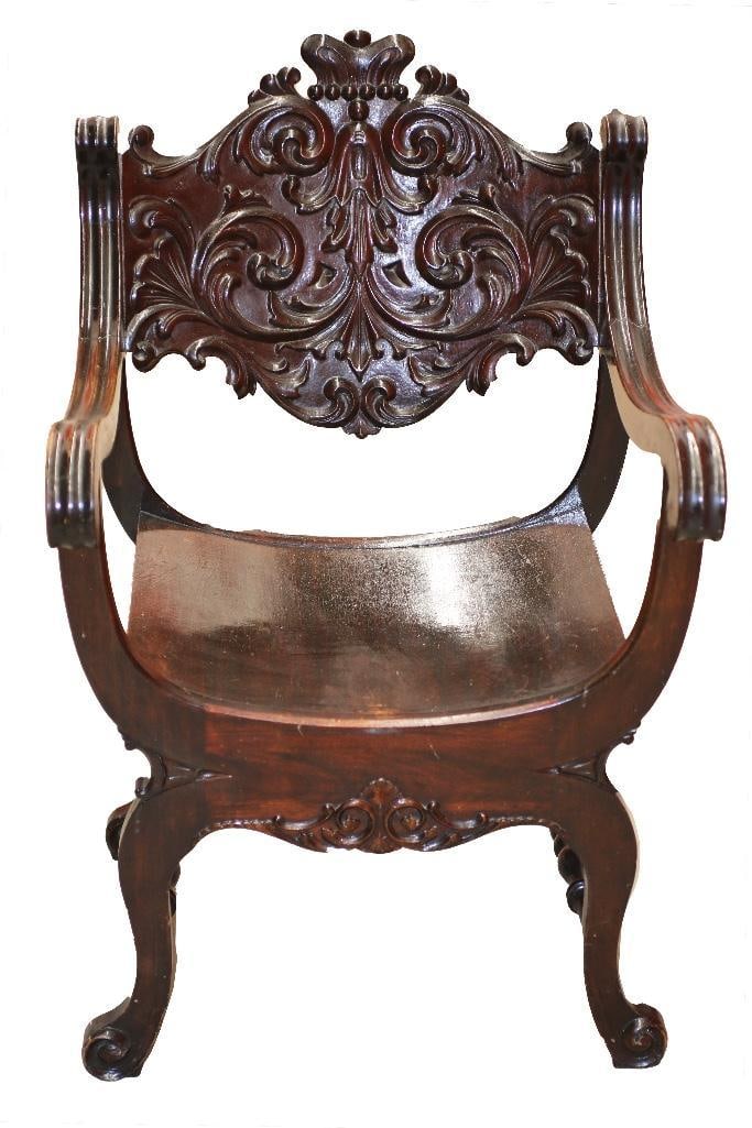 A Lacquered Italian Style Wood Chair: Continental, 20th century. A sturdy chair with scoop seat in a dark finish. Complete with ornate carvings and high lacquer.