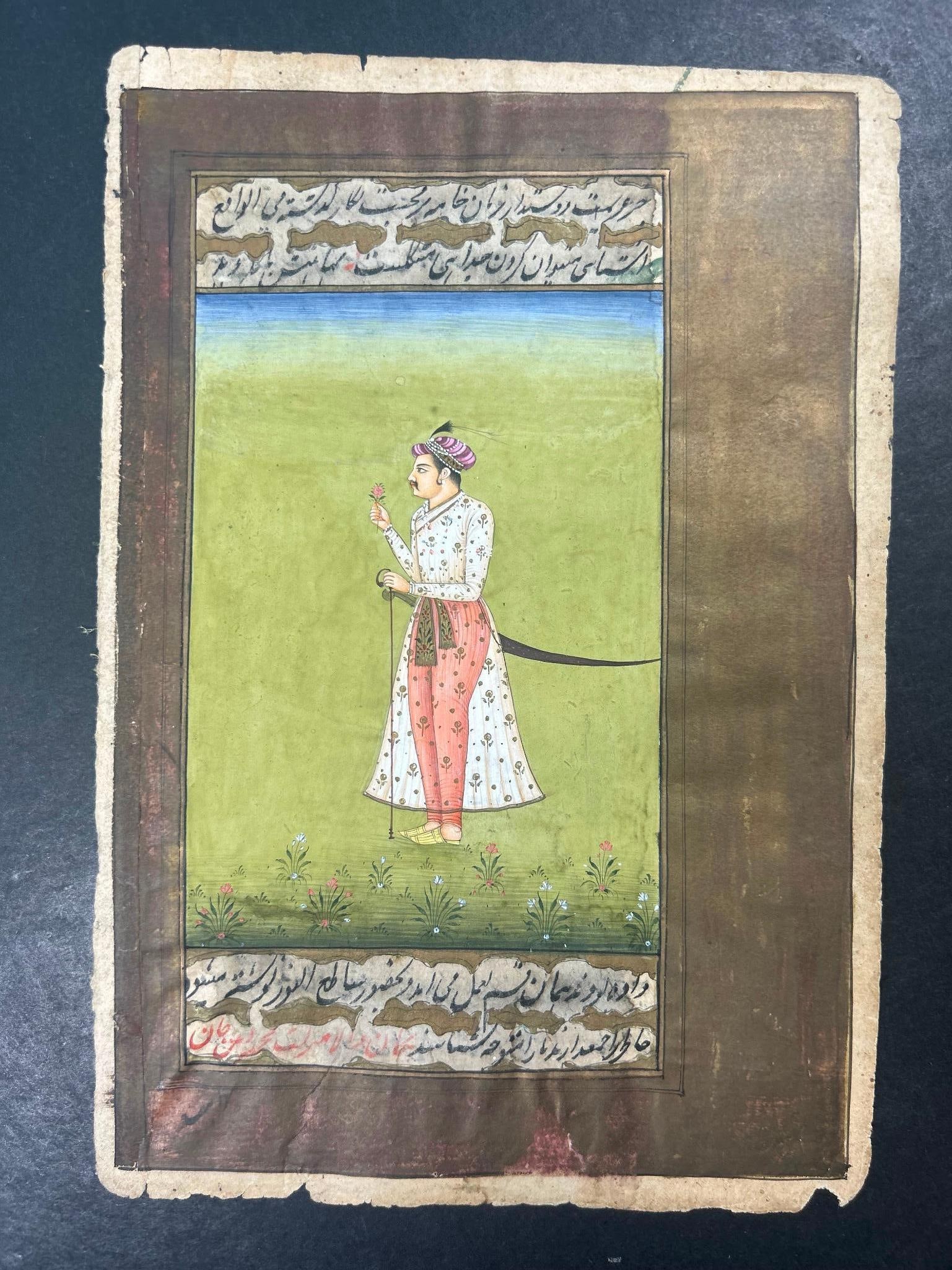 Miniature Opaque Watercolor Portrait With Persian Text: Miniature Opaque Watercolor Portrait With Persian Text. Features a man with a flower, cane, and shamshir. Page measures approximately 5 1/2" x 8" Overall good condition, some loss to edges.