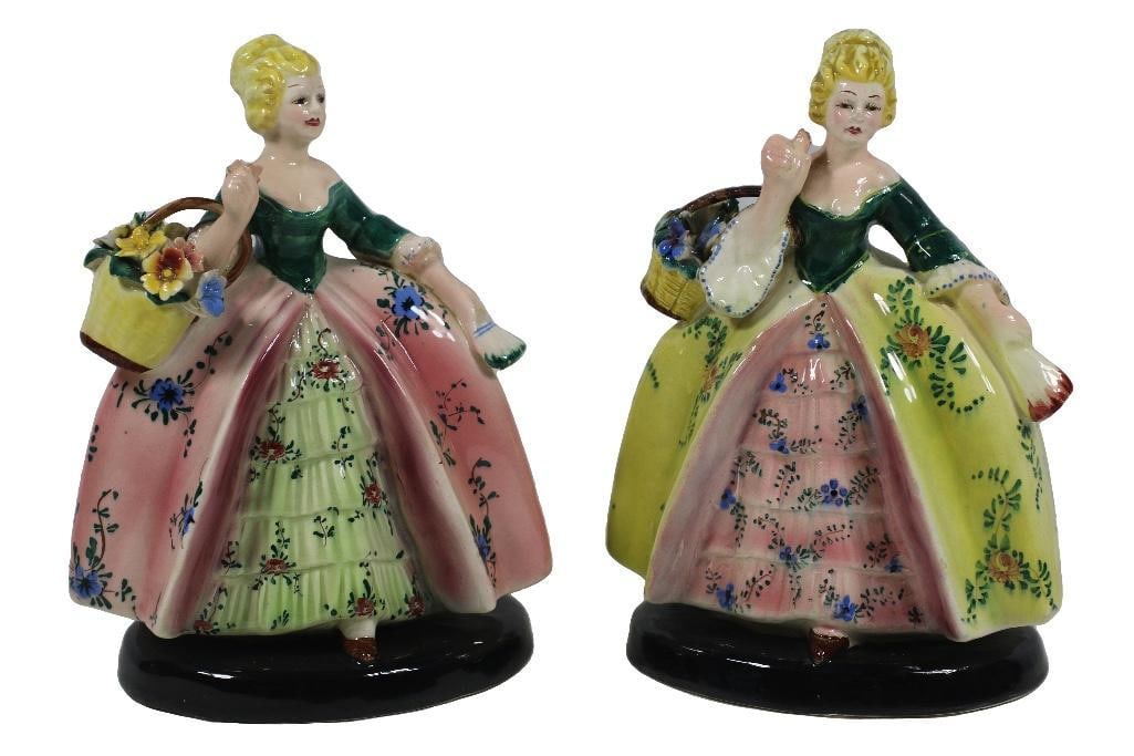A Pair of Italian Porcelain Ladies with Flowers: Italy, 20th century. A pair of hand-painted figurines of women having flower baskets. Marked underside and numbered. Overall good condition. 6 x 8 inches each.