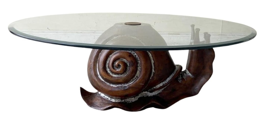 A 1970s Snail Table by Federico Armijo: A 1970s Snail Table by Frederico Armijo Snail: 15" L x 19" H Round glass: 32" diameter Overall good condition, some loss to finish Materials: wood and glass