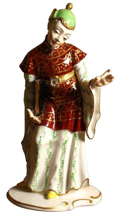 A Porcelain Chinese Priest Figurine: Continental, 20th century. Designed by Franz Anton Bustelli, marked "Chelsea House" underneath. In good condition.