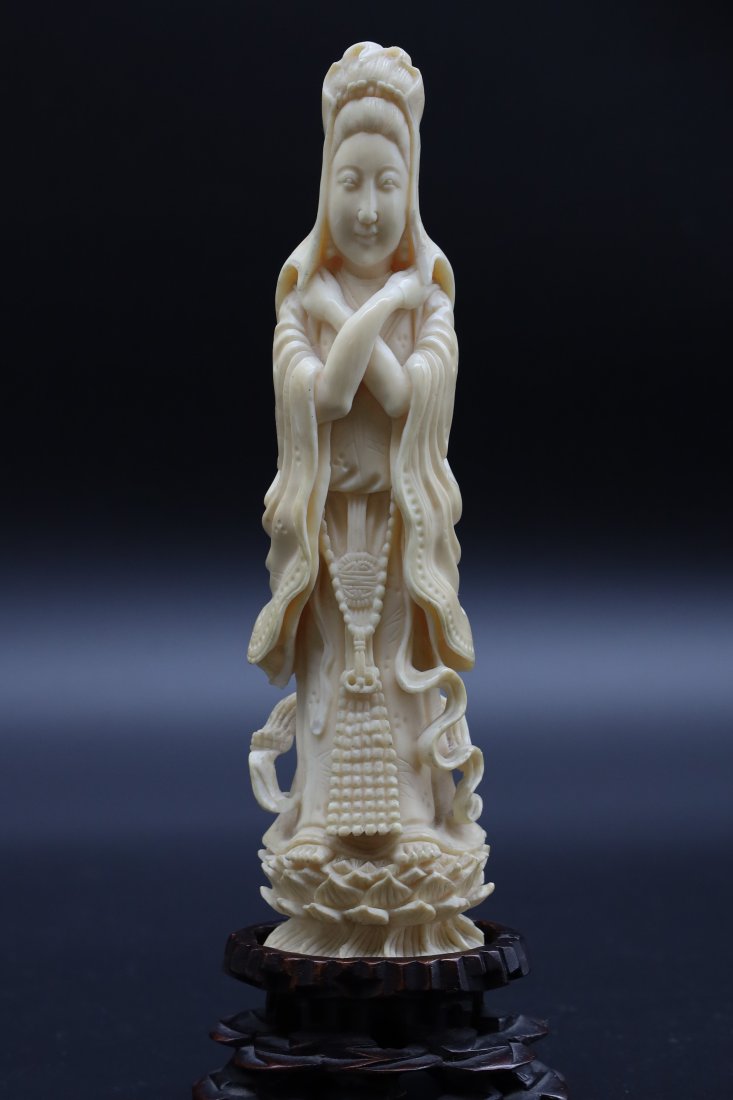 Antique Chinese carved bone statue: Very well executed. Some minor damage to the scarf and around the shawl. 7"H with wooden stand