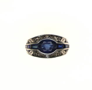 Vintage Platinum Ring with Filigree and Sapphires: This elegant platinum and sapphire ring has an elegant filigree setting surrounding the sapphires. 1 center oval sapphire with 6 baguette sapphires complimenting the center stone. 6.7grams Platinum