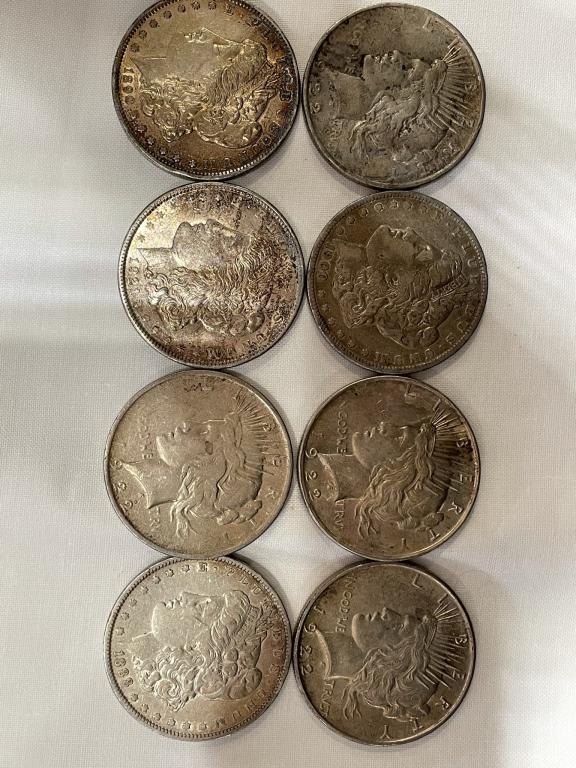 A  LOT OF EIGHT US SILVER DOLLARS This lot includes a (1 of 2)