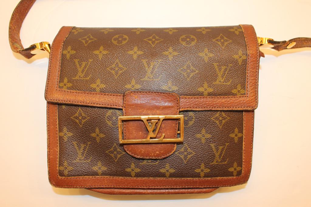 LOUIS VUITTON VINTAGE MONOGRAMED PURSE: Measures 10" across, 7" tall plus shoulder strap. Has the LV lovo in brass to front as well 1980's