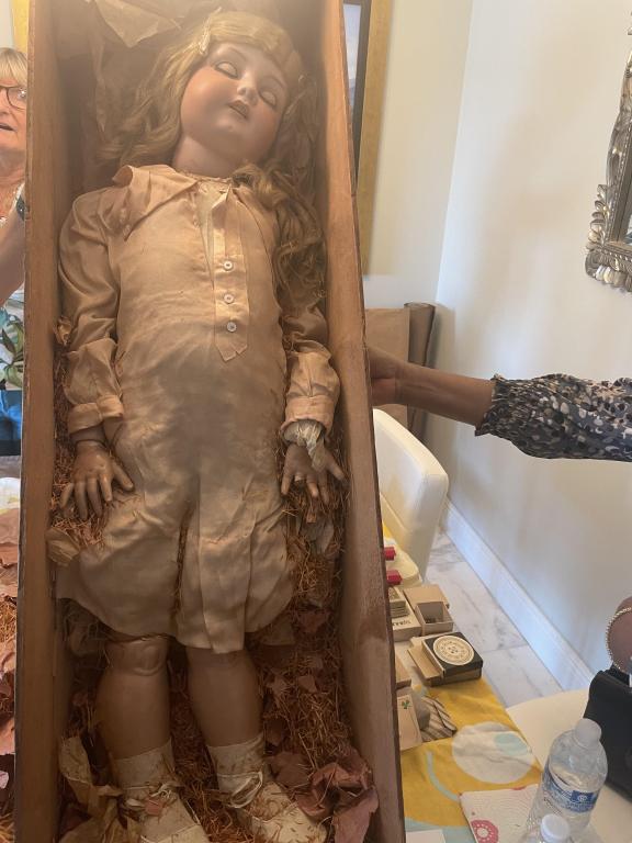 ARMAND MARSELLE GERMAN 19TH CENT LG BISQUE DOLL: She is about 42” long, comes in the original wooden box. She is missing one finger, has all the original clothes, was appraised by Billy Harris of the antique road show for $2000. Label says Fol