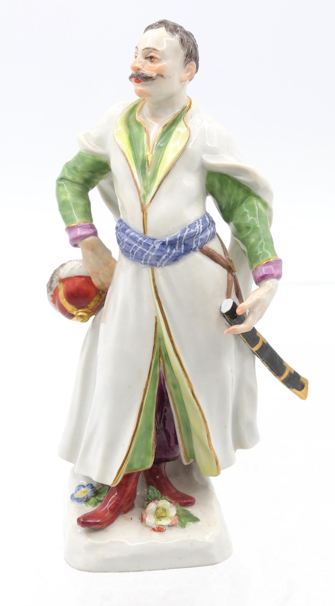 Meissen Polish Noble Figurine: Porcelain figurine depicting a man in Polish garb with hat in hand, featuring gilt accents throughout. Marked on the base with double sword marking and incised numbers "496" and "29". Sword piece is b