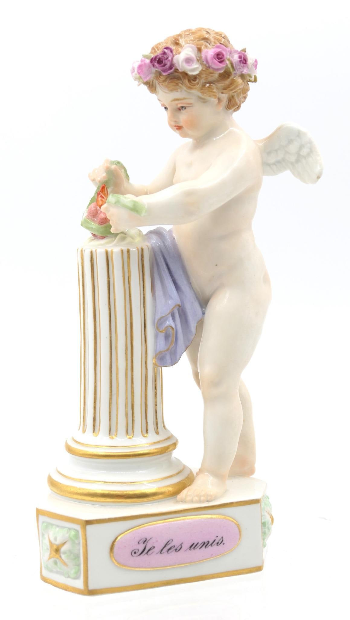 Meissen "Je Les Unis" Figurine: Porcelain figurine depicting Cupid tying up a flame, with the words "I Unite Them" in French. Marked with double sword marking on the base, and incised numbers "F. 1" and "65". Attributed to Michel Vi