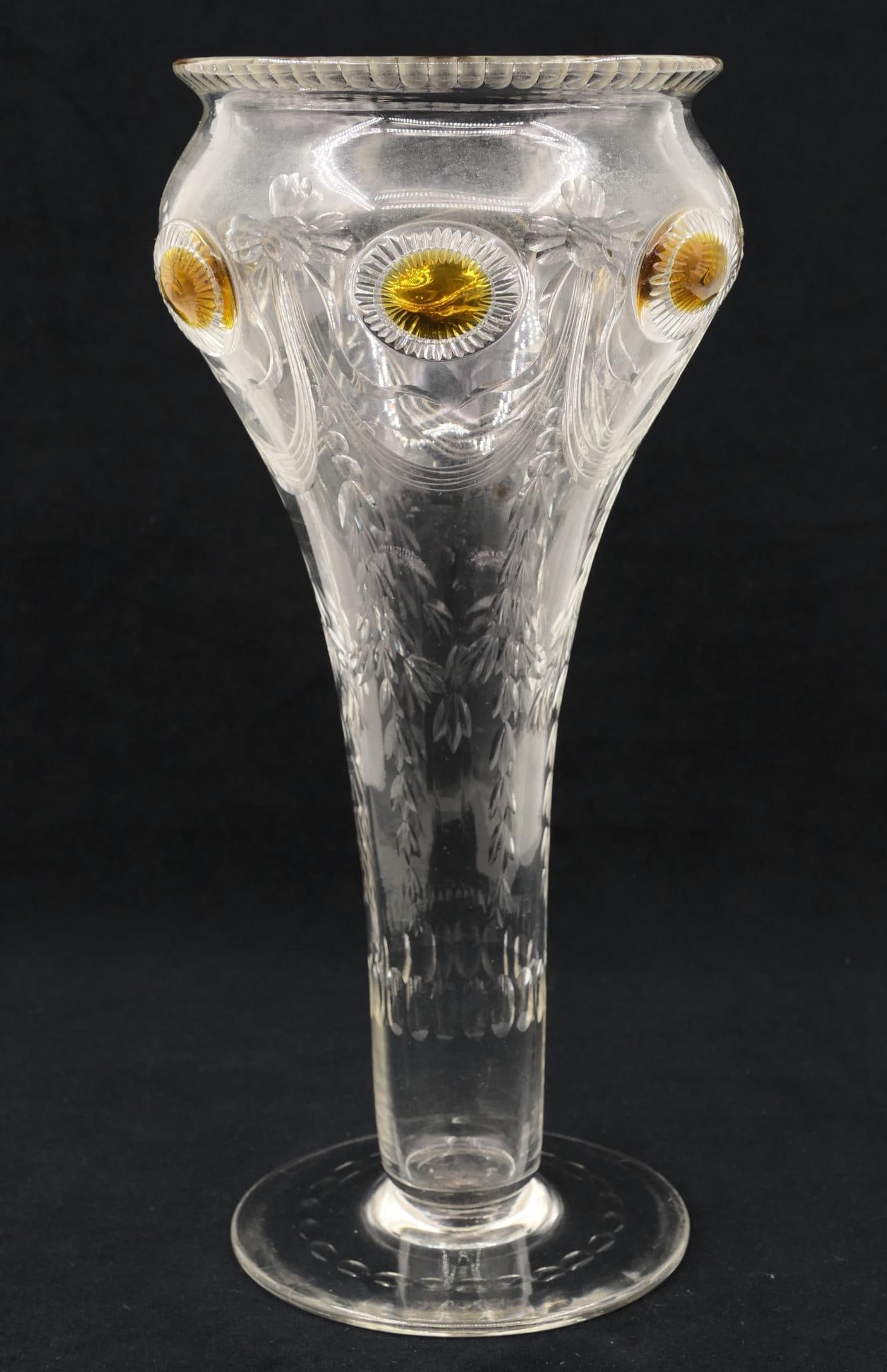 Thomas Webb & Sons Vase: Early 20th century Art Nouveau glass vase featuring floral and foliate garland accenting and yellow medallion details from Thomas Webb & Sons. Webb mark on base.Size: 10" h