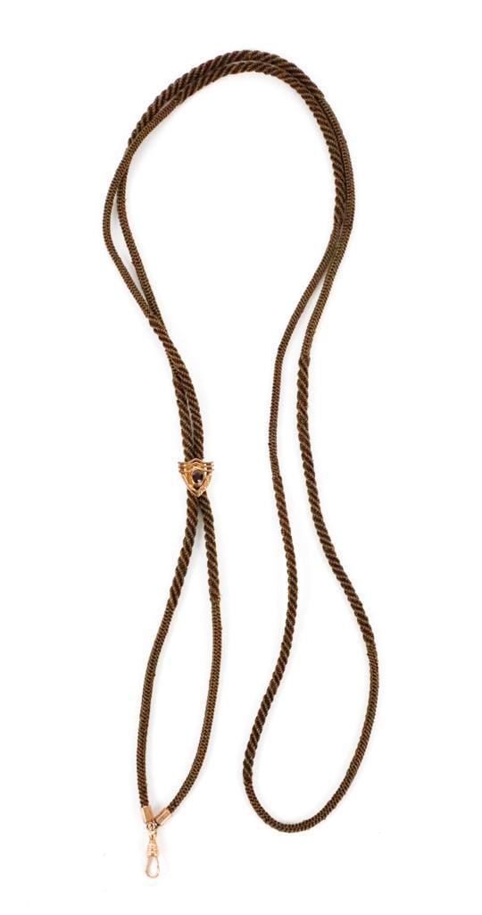 Victorian Hair Work Watch Chain: Victorian hair work watch chain with bezel set garnet in etched gold frame. Swivel bail marked 14k.? Size: 25"l when clasped, 50" full length Location: Showcase