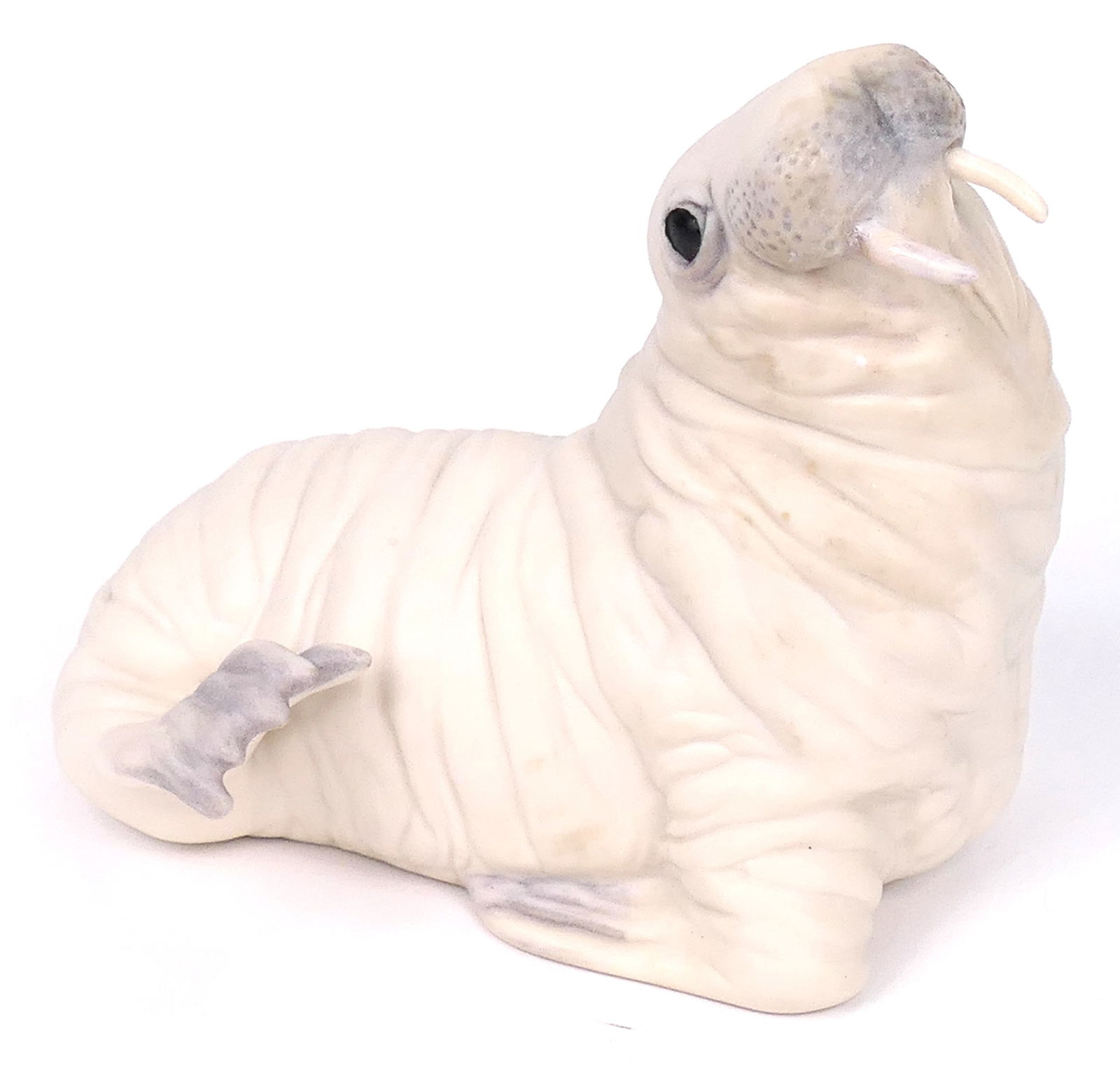 Cybis "Wellington Walrus" Figurine: Porcelain figurine by Cybis titled "Wellington Walrus", depicting a white walrus with a heavily wrinkled texture. Marked Cybis USA. Size: 5"L x 4.5"h