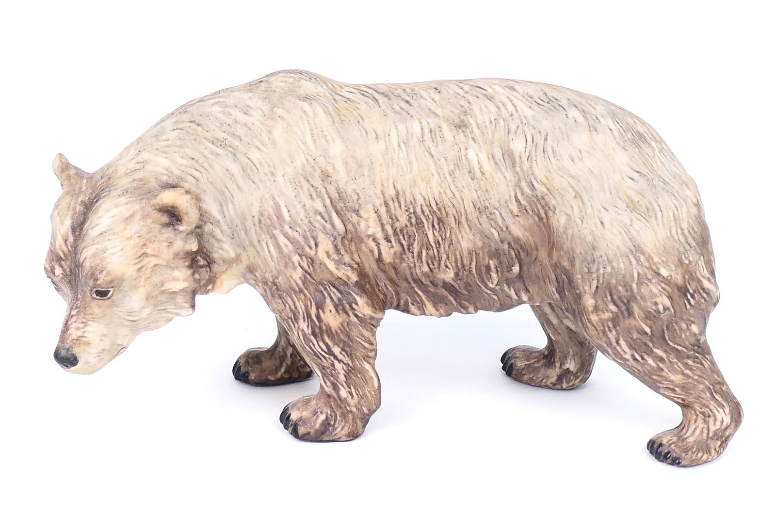 Cybis "Bear" Figurine: Porcelain figurine titled "Bear", depicting a bear with mottled brown fur. Marked on the bottom. Size: 8"L x 4.25"h