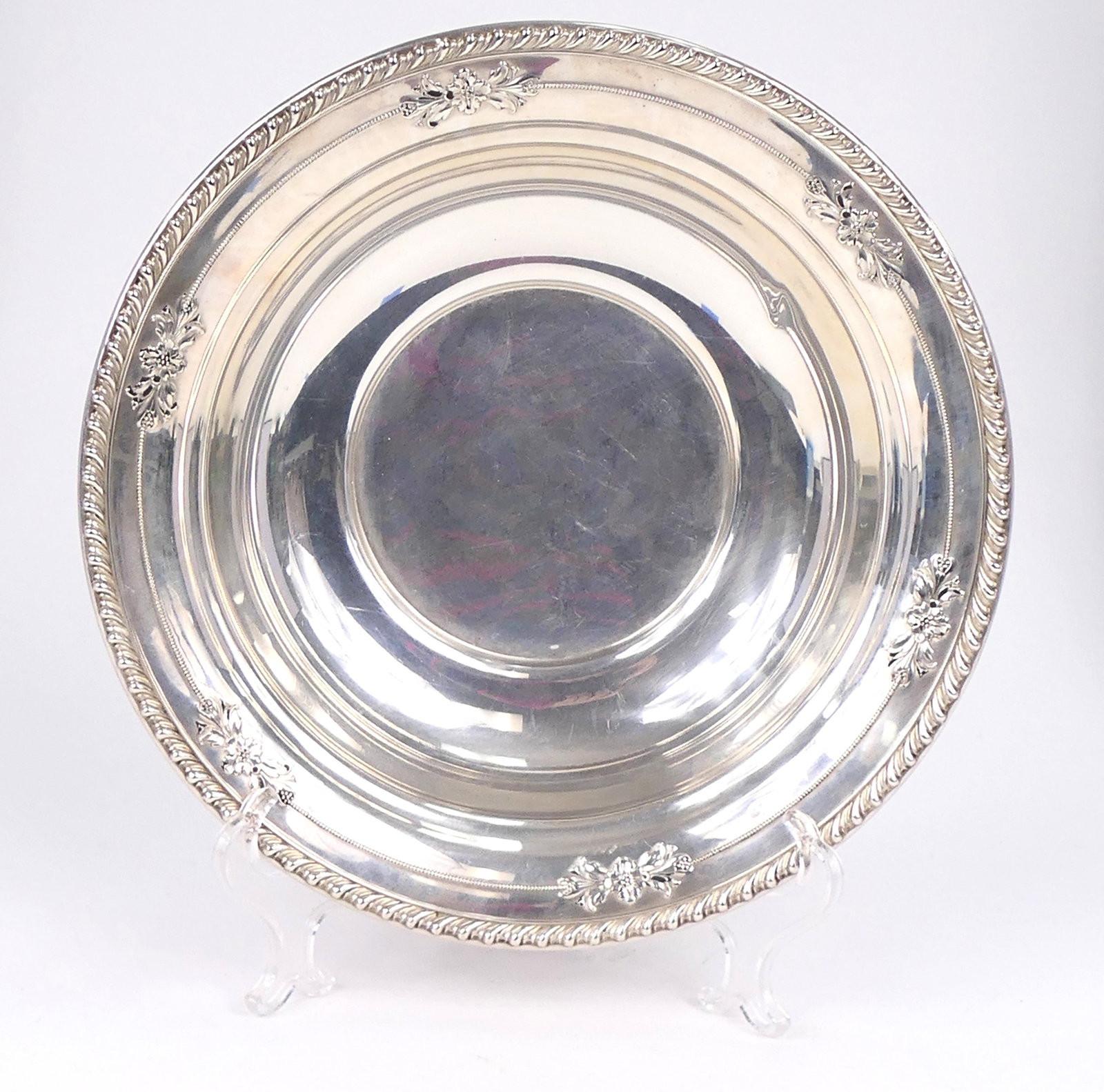 Sterling Silver Bowl by Wallace: Sterling silver bowl by Wallace featuring floral and swag accenting. Marked Sterling 225. One side shows a dent. Weight: 7.3ozt Size: 10"dia