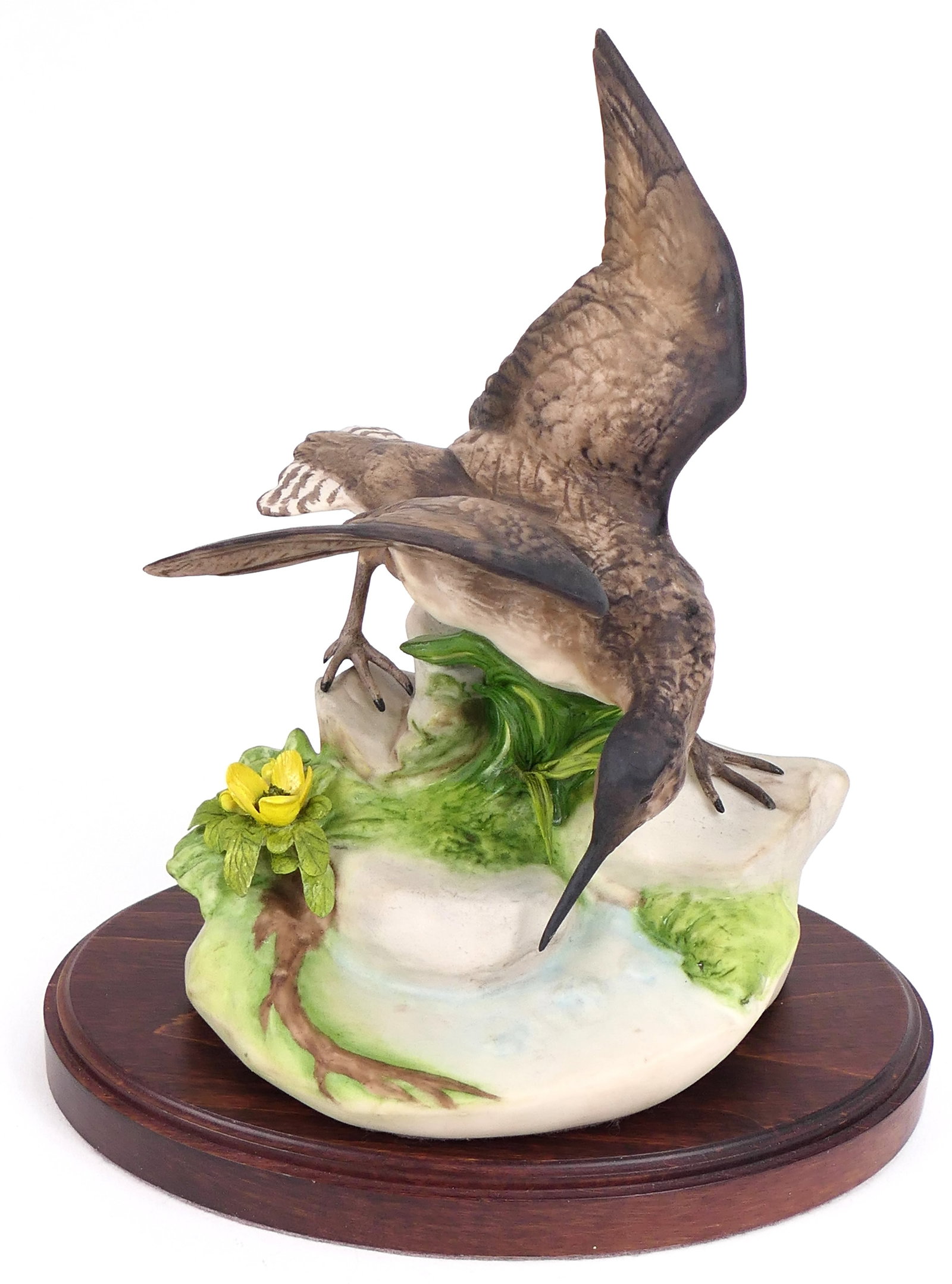 Cybis "Solitary Sand Piper" Porcelain Figurine: Porcelain figurine by Cybis titled "Solitary Sandpiper" (flower version). Marked on the base and numbered 94. Removable from included wooden base. Size: 6"w x 5"d 9"h