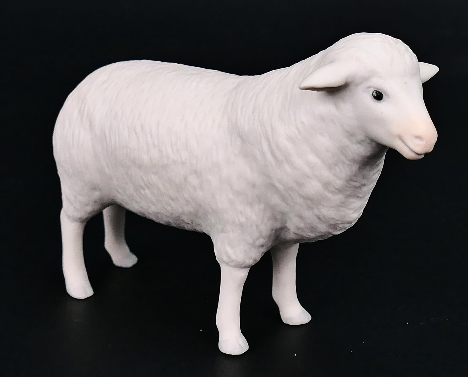 Cybis Sheep Figurine: Porcelain figurine by Cybis depicting a sheep. Signed on the belly with Cybis stamp and dated 1981. Size: 4.5"w
