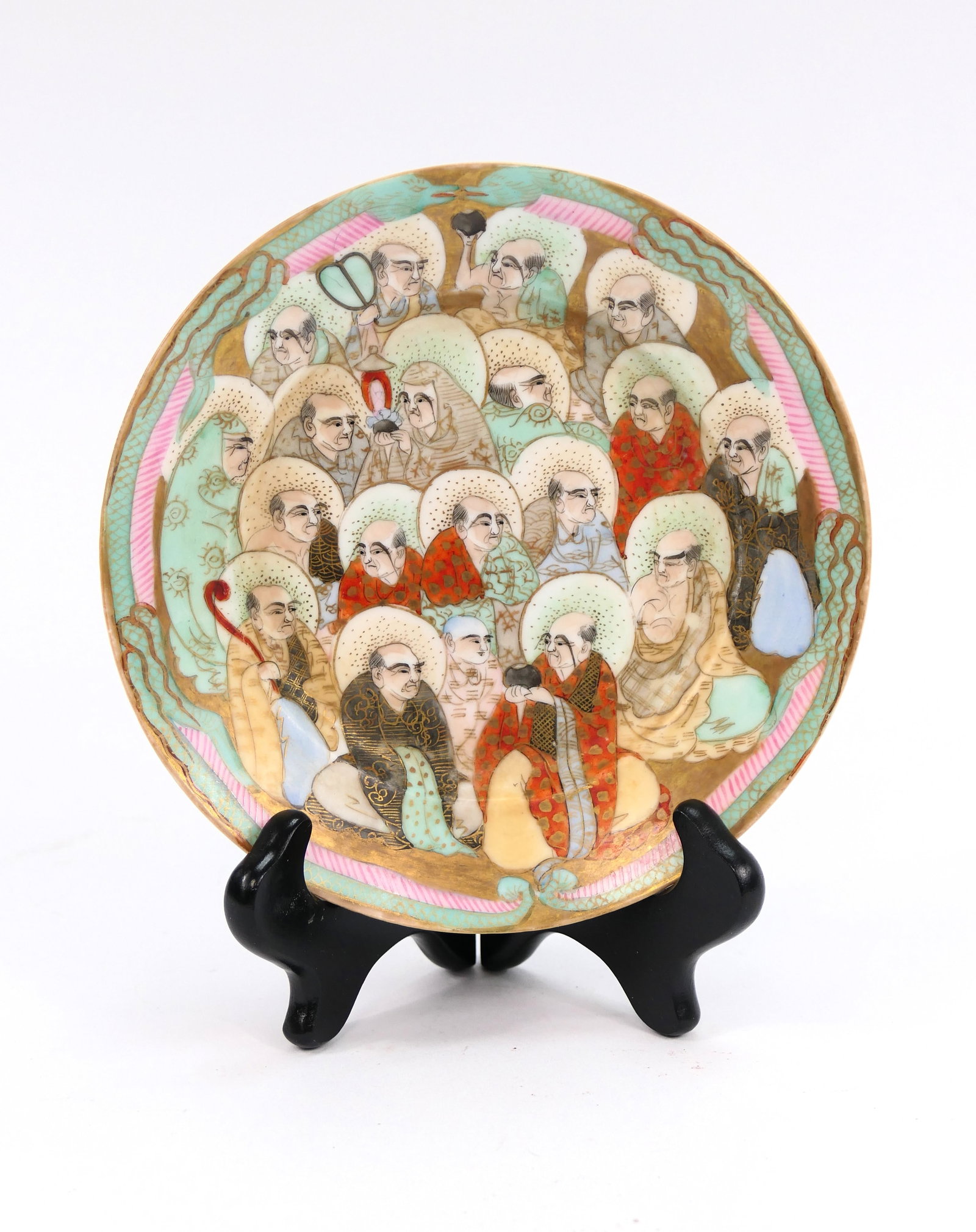 Antique Japanese Satsumaware Plate: Antique Japanese Satsumaware Meiji period (1868-1912) plate featuring a design of many Arhats with halos behind their heads. Size: 6"dia
