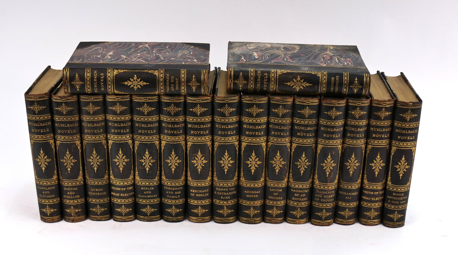 Muhlbach Novels in Seventeen Volumes: Seventeen antique volumes of Muhlbach's Novels, published by D. Appleton & Co. 1897-1898. Surface wear and discoloration are evident, commensurate with age, reading, and storage.