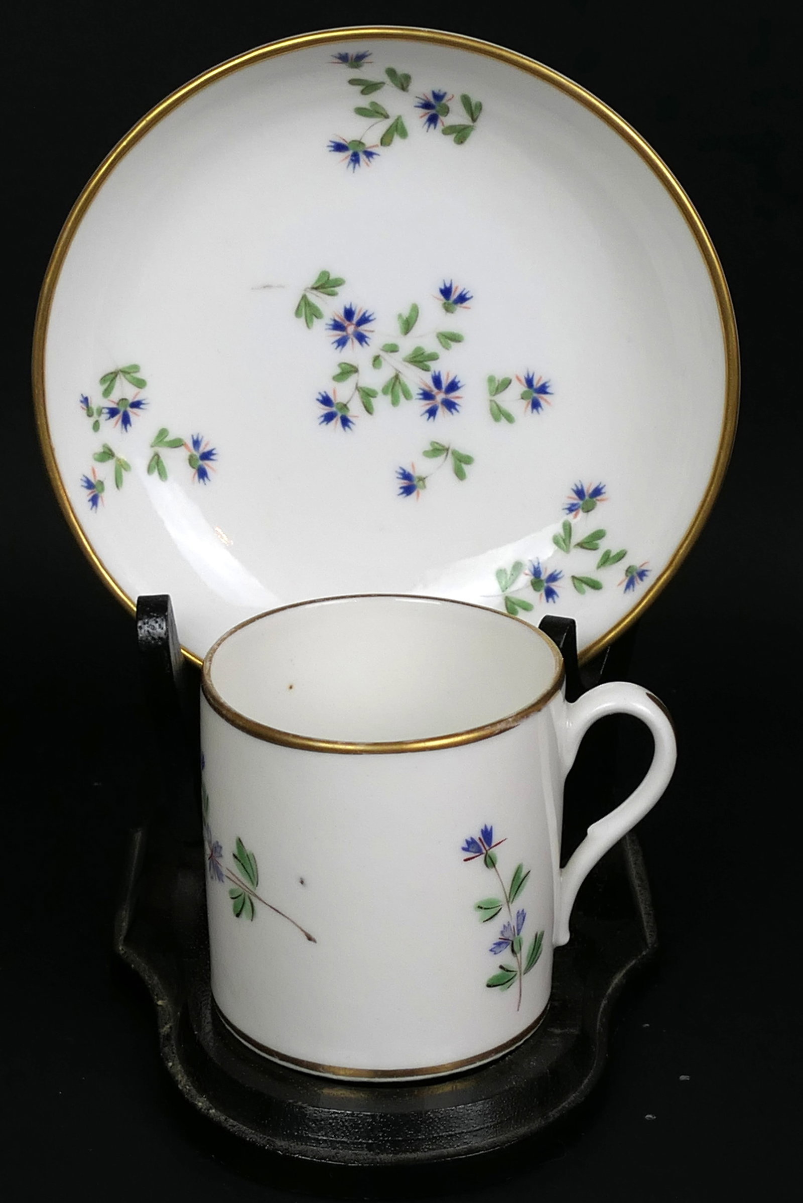 Antique Nast French Corn Flower Teacup and Saucer: Circa late 1700's French teacup and saucer by Nast a Paris in corn flower pattern featuring gold tone accent border. Size: Saucer 5"dia Location: Dining Room