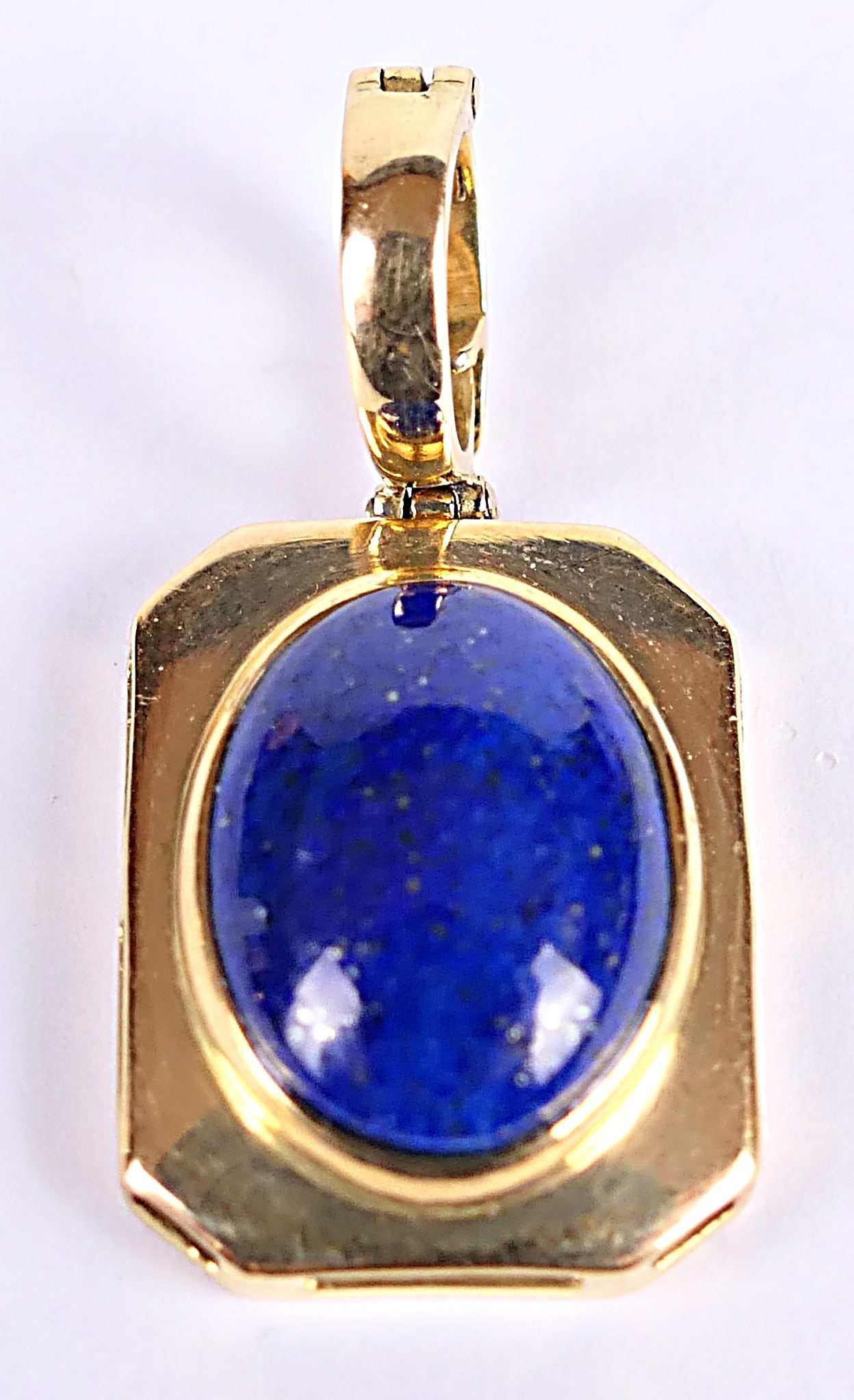 18kt Blue Stone Cabochon Pendant: 18kt gold pendant featuring a rectangular shape, set with a dark blue stone cabochon. Weight: 3.7dwt Size: 1.25"L with bail Location: Showcase
