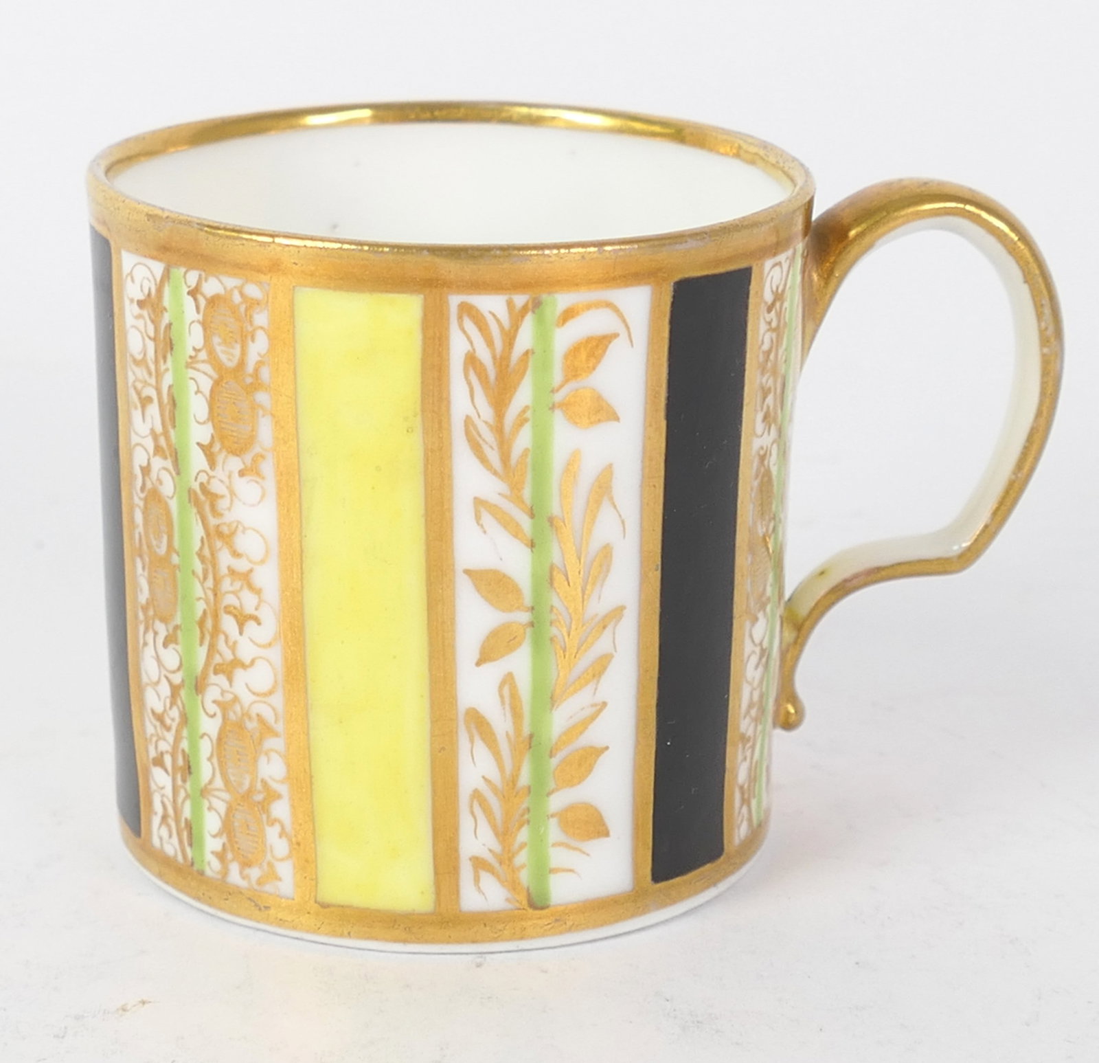 Sevres Coffee Can: Sevres coffee can in vertical pattern with gilded features and foliate motif. Size: 2.5"dia x 2.25"h