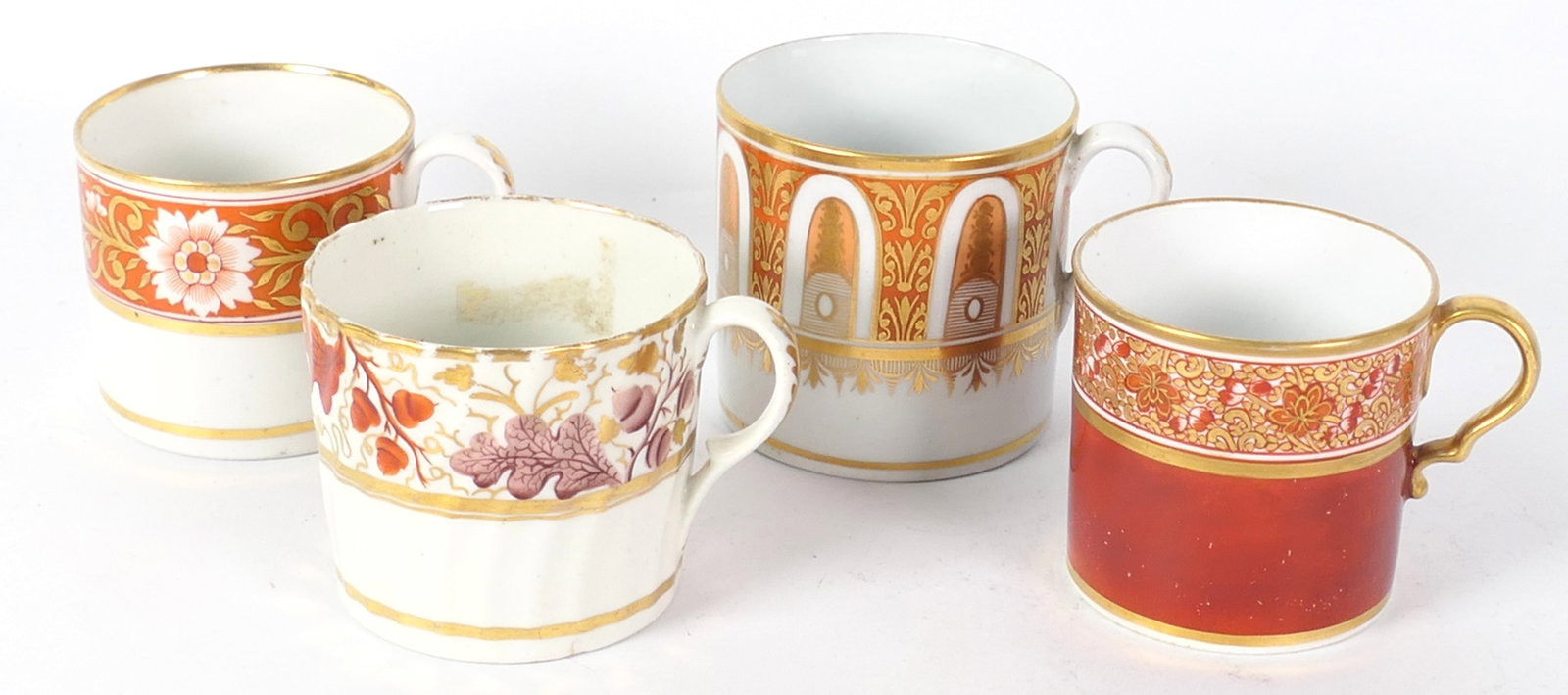Four English Red and White Coffee Cans: Four English red and white coffee cans of various patterns with gilded features and floral, foliate and scroll motif. Size: 2.75"dia x 2.75"h