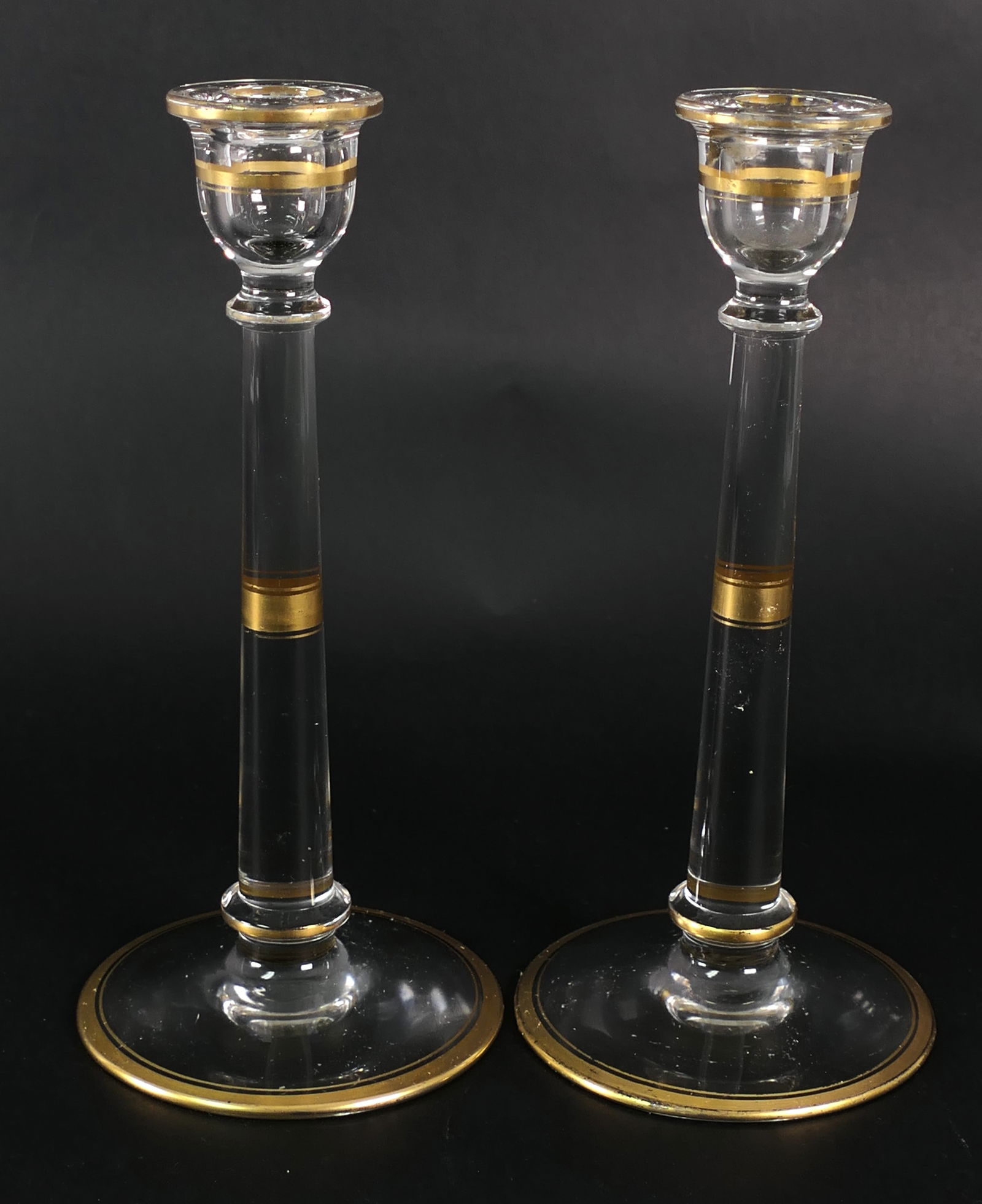 Pair of Glass Candlesticks with Gold Bands: Pair of glass candlesticks with bands of gold trim on the capital, column and base. Color loss, wax residue. Size: 9"h