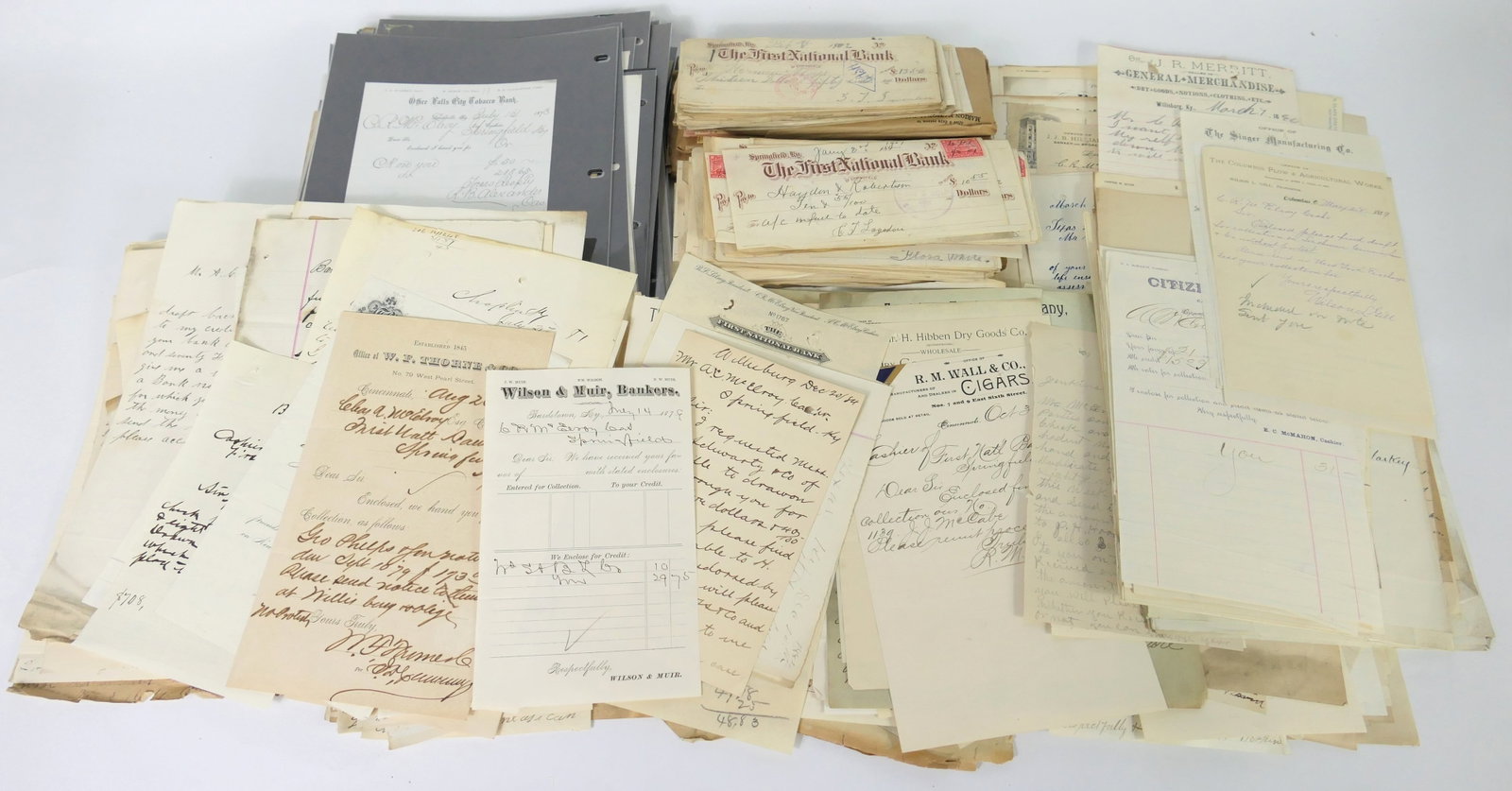 Assorted Bank Ephemera: Assorted bank and transactional ephemera including assorted cheques from First National Bank, Livestock Broker, Office Falls City Tobacco Bank, R.M. Wall & Co Cigars, and more. Dates mostly include 18