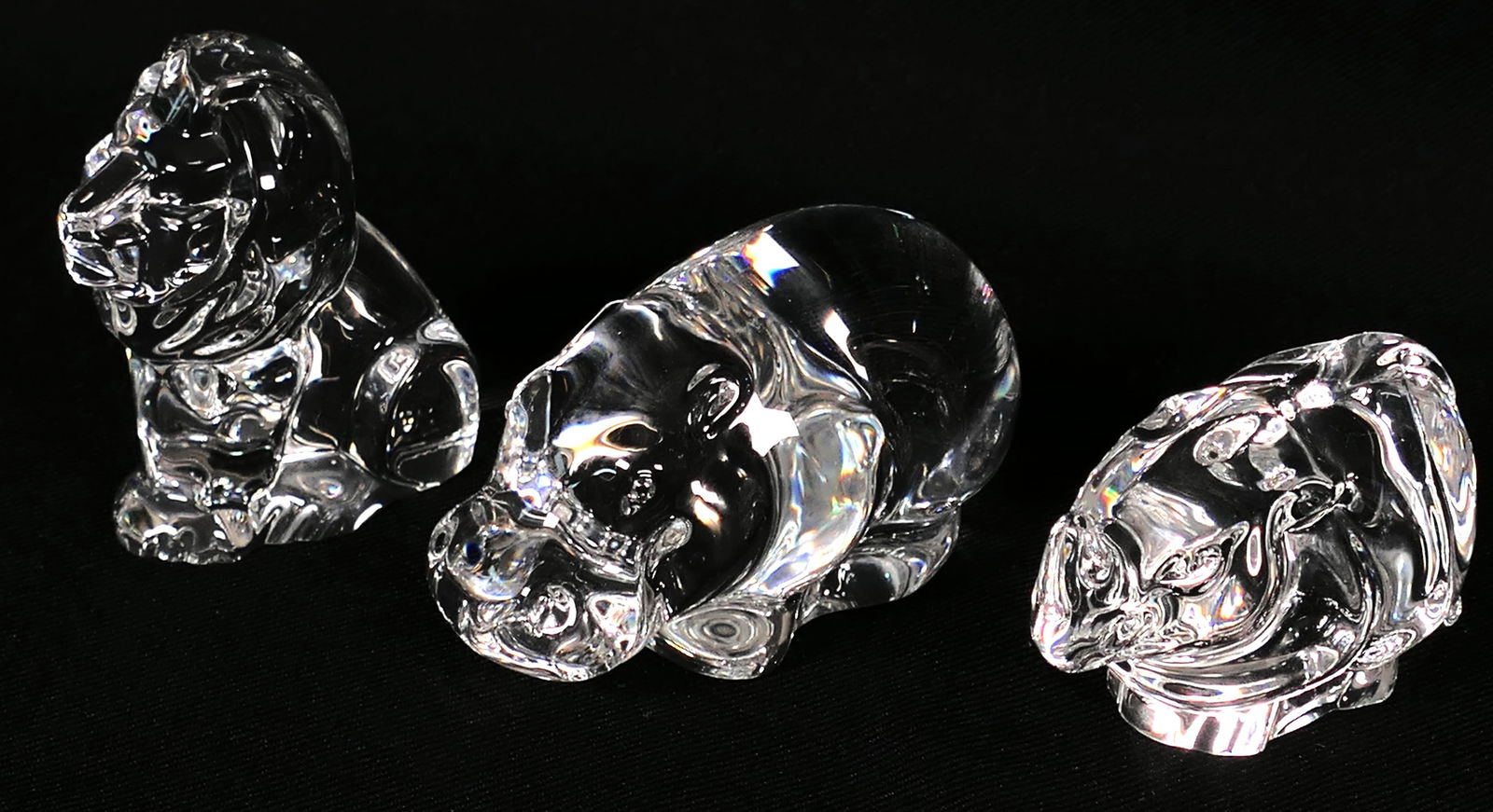 Three Steuben African Animals: Three Steuben "Hand Cooler" African animals including hippo, rhino and lion, designed to be nestled in the palm of a hand to keep it cool and dry. Marked with etched signature. Size: Location: Den