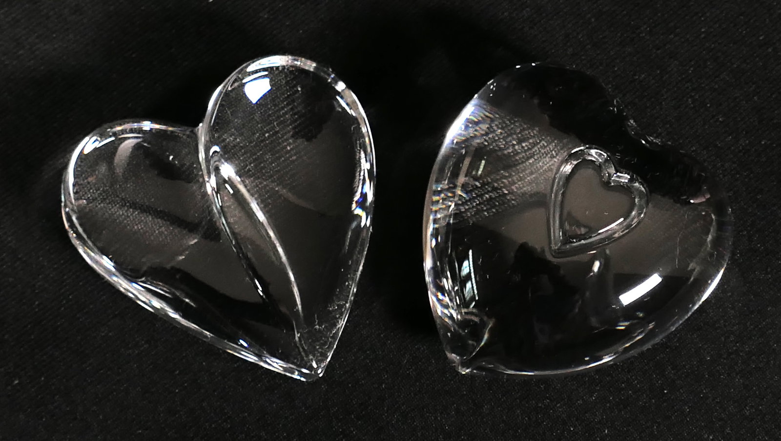 Two Steuben Heart Paperweights: Two Steuben crystal heart paperweights. Marked with etched signature. One box included. Size: 2.5"w Location: Den