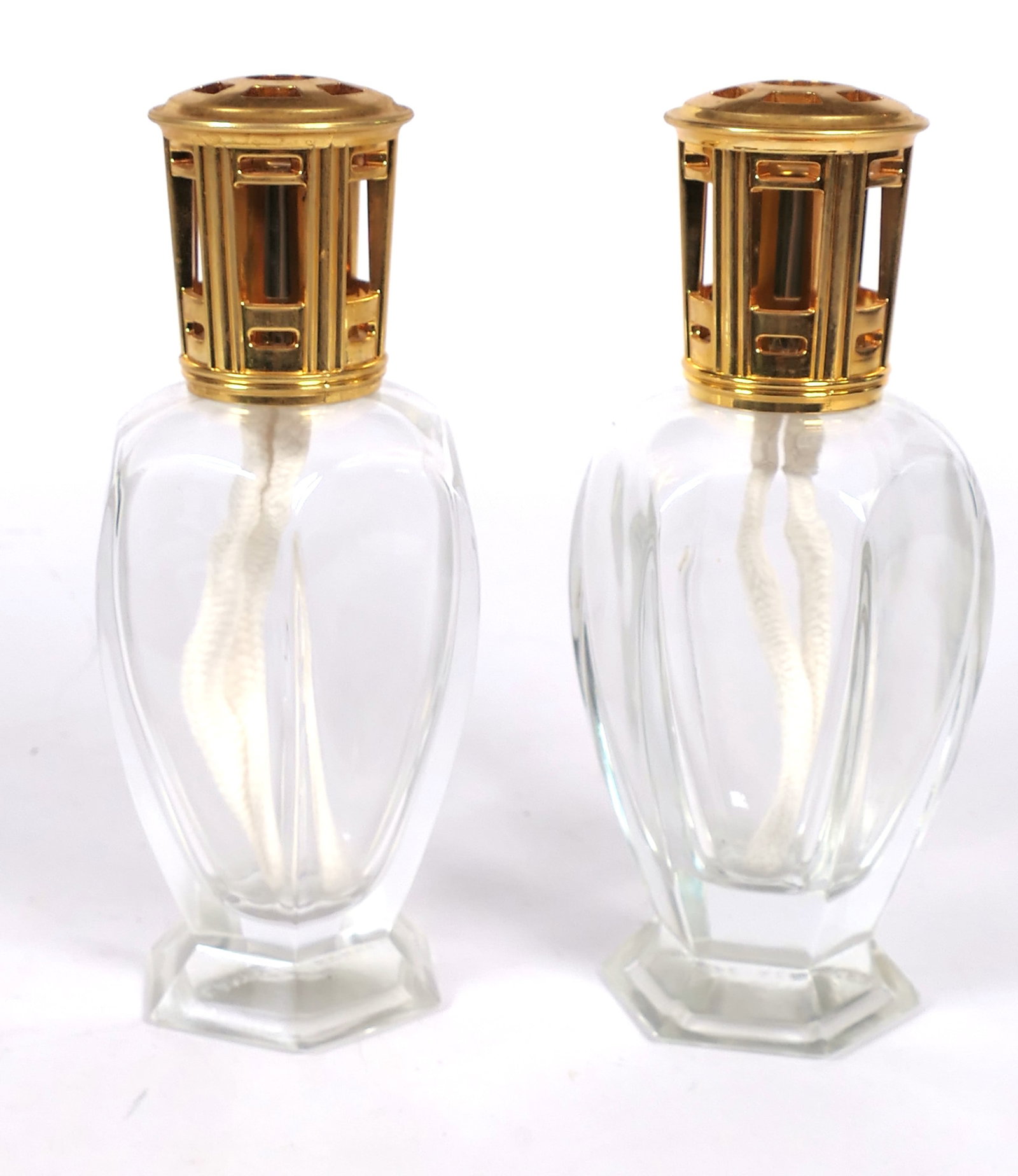 Pair of Berger Oil Fragrance lamps: Pair of Lampe Berger oil fragrance lamps in Athena pattern with brass lid. Size: 7.5"h Location: Sunroom