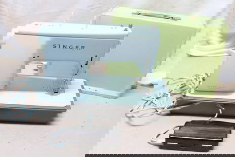 1960's Singer Sewing Machine: 1960's Singer sewing machine model 347 in pale blue with pale green cover. Powers on and needle goes up and down. Location: Garage