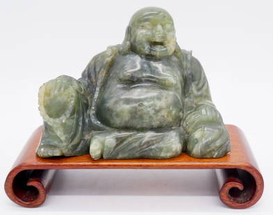 Hand Carved Spinach Jade Seated Laughing Buddha: Hand carved spinach jade seated Laughing Buddha. Rectangular scrolled footed base included. Size: 5"w x 3"h without base Location: Sitting Room