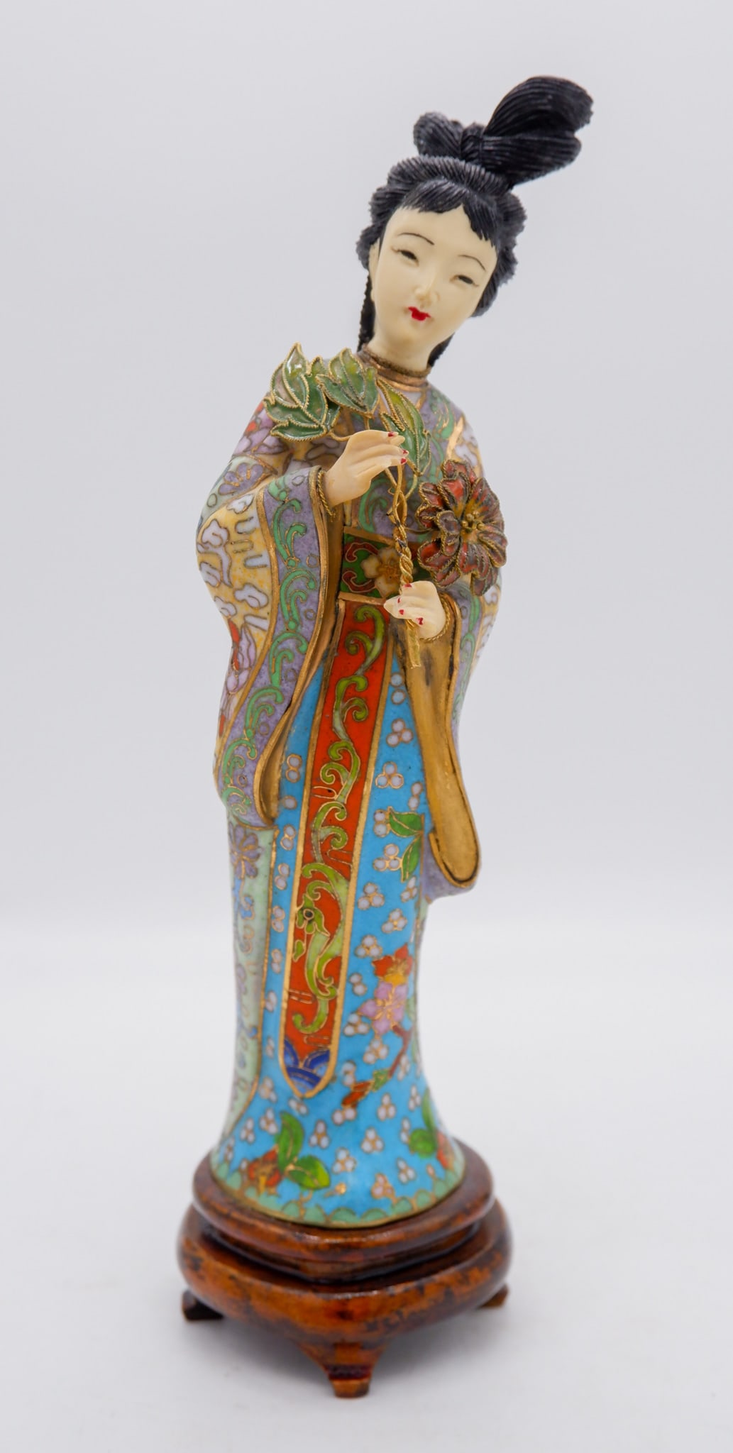 Carved Bone Geisha Cloisonne Figurine: Carved bone cloisonne figurine of a geisha holding flowers on attached wooden base. Size: 9.75"h Location: Sitting Room