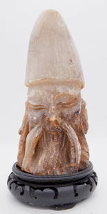 Soapstone Hand Carved Bust: Soapstone hand carved bust of elder male figure featuring long beard, tall curved pointed hat, long ears, and chevron carvings on back and sides. Includes carved wood base. Size: 8"h Location: Living