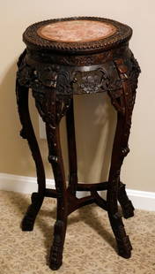 Antique Chinese Round Art/Plant Stand: Antique Chinese art/plant stand with detailed floral and foliate carving, canted corners, lower stretcher supports and formed legs. The base wood may be rosewood. Size: 17"dia. x 32"h Location: Office