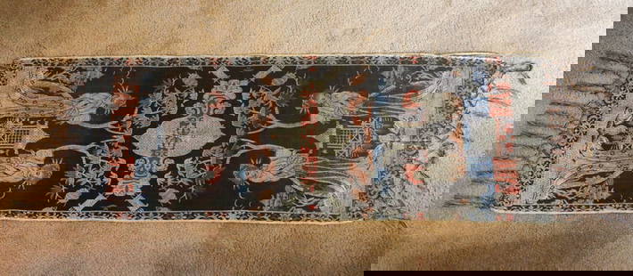 Tapestry Wall Hanging: Embroidered silk tapestry wall hanging with an Asian motif. It features two women with a pagoda style building in the background and has a decorative border with fringe. Some edging has come loose. Si