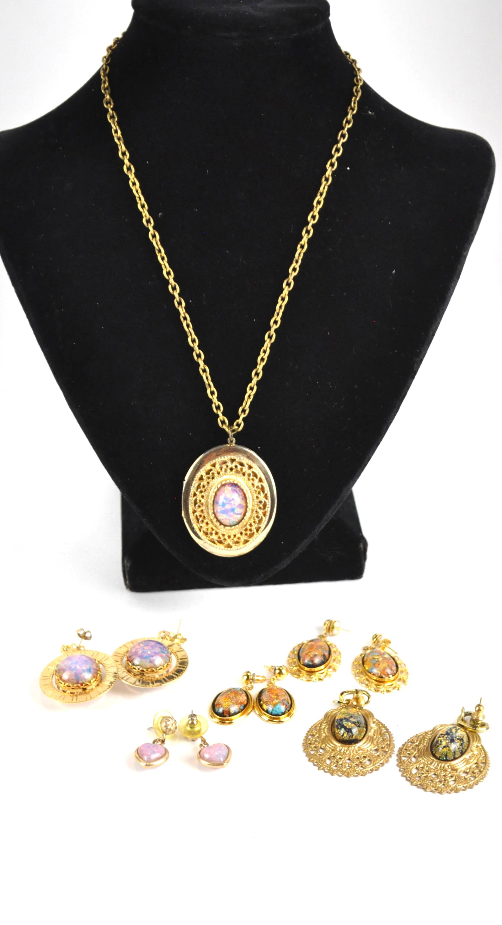 Rainbowflake Locket Necklace and Earrings: Rainbowflake necklace with locket pendant with matching dangle earrings, plus 4 more pairs of rainbowflake earrings with filigree accents. Size: Locket 1.5"w x 2"h Location: Showcase