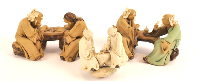 Three Pairs of Mudmen Seated at Tables