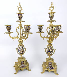 Pair of Ornate French Gilt Candelabras: Pair of ornate French candelabras with three arms and center featuring floral and scroll works motifs, enamelwork in the base, middle urn and removeable finial for center. Some cleaner residue, surfac