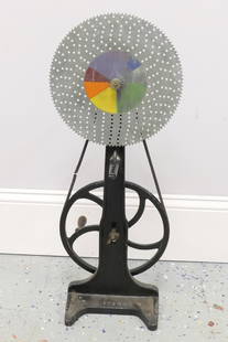 Newton's Color Wheel: Newton's color wheel by W. M. Welch Scientific Co., used to demonstrate how white light is composed of the colors of the spectrum. When disk is spun rapidly colors blend together and disk appears whit