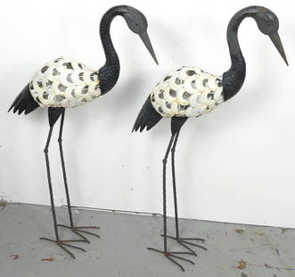 Pair of Metal Crane Garden Statues: Pair of filigree metal crane garden statues with crackle ivory finish. Body separates from legs, missing rounded support on feet. Size: 20"w x 5"d x 35"h